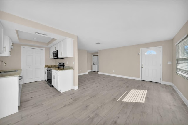 kitchen featuring sink, white cabinetry, stainless steel appliances, and light wood-type flooring