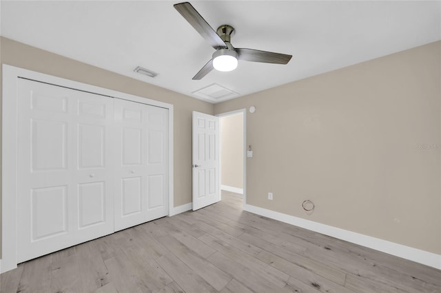 unfurnished bedroom featuring ceiling fan, light wood-type flooring, and a closet