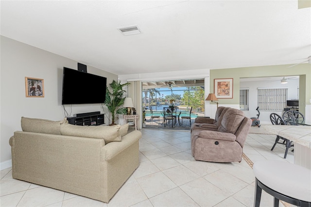 living room with ceiling fan and light tile patterned floors