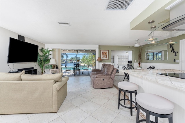 living room with ceiling fan and light tile patterned floors