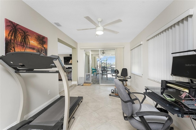 exercise area featuring ceiling fan and light tile patterned floors