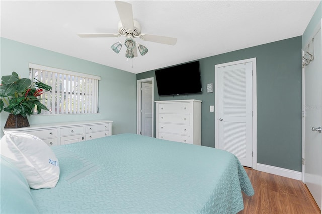 bedroom with ceiling fan and light hardwood / wood-style flooring