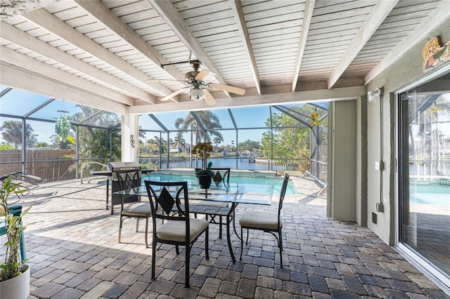 view of patio / terrace with a fenced in pool, glass enclosure, and a water view