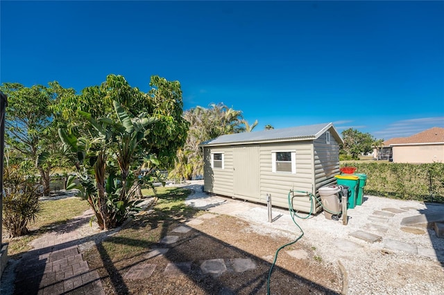 back of property featuring a shed