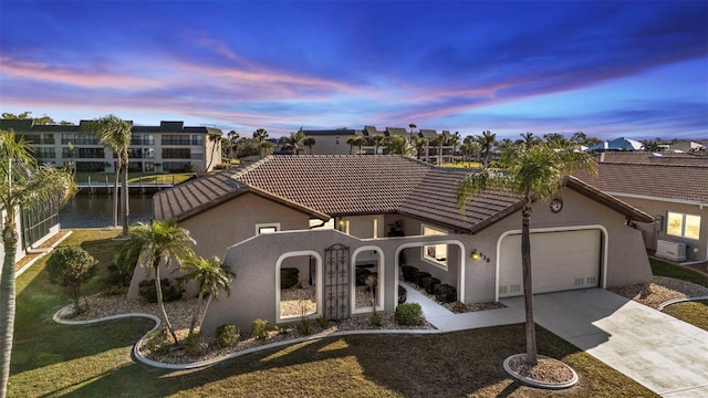 view of front of home featuring a water view and a garage