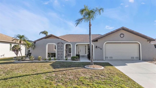 view of front of property with a front yard and a garage