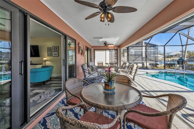 sunroom with a swimming pool and ceiling fan