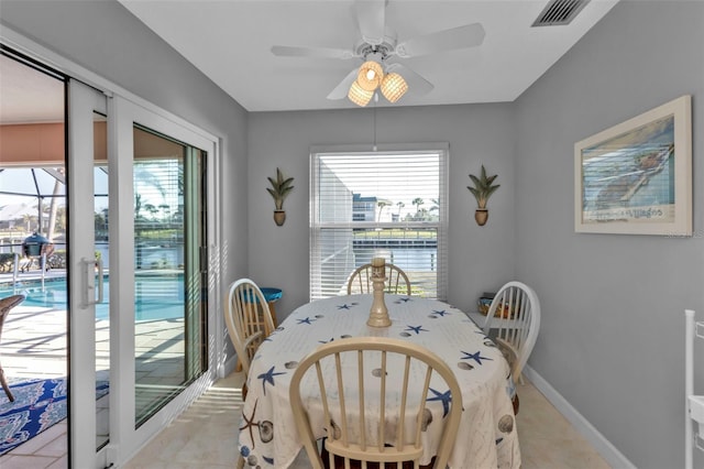 tiled dining space featuring ceiling fan