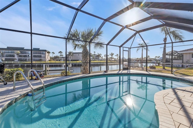 view of swimming pool with a lanai and a water view