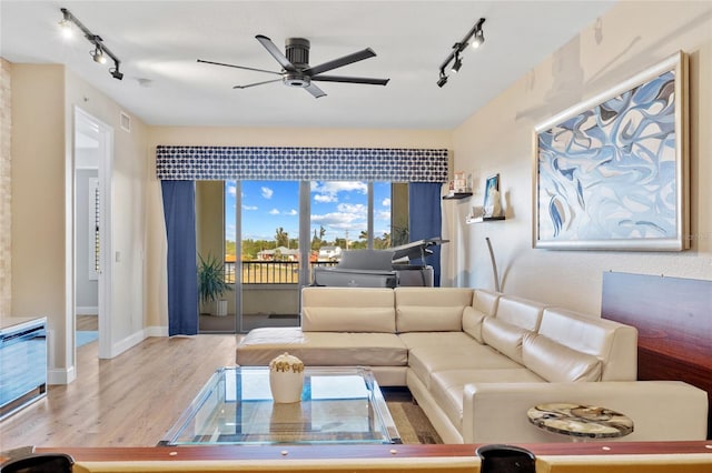 living room featuring ceiling fan and hardwood / wood-style floors