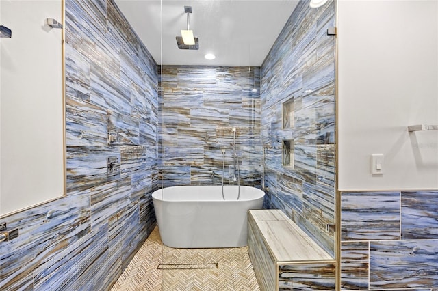 bathroom featuring tile walls, tile patterned floors, and a tub