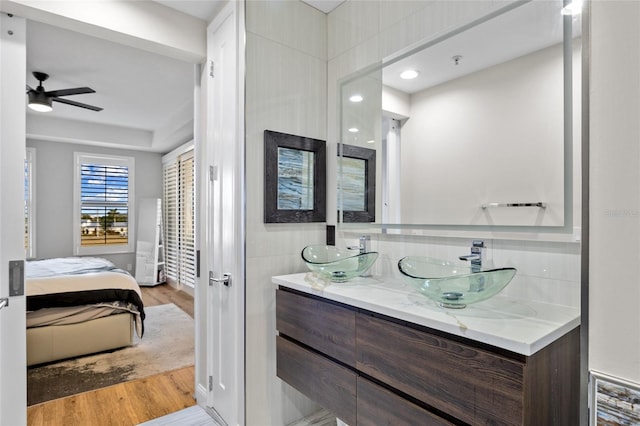 bathroom featuring hardwood / wood-style flooring, vanity, and ceiling fan