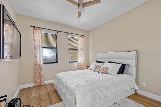 bedroom with ceiling fan and light hardwood / wood-style floors