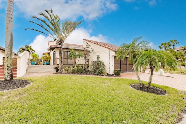 mediterranean / spanish house featuring a front lawn