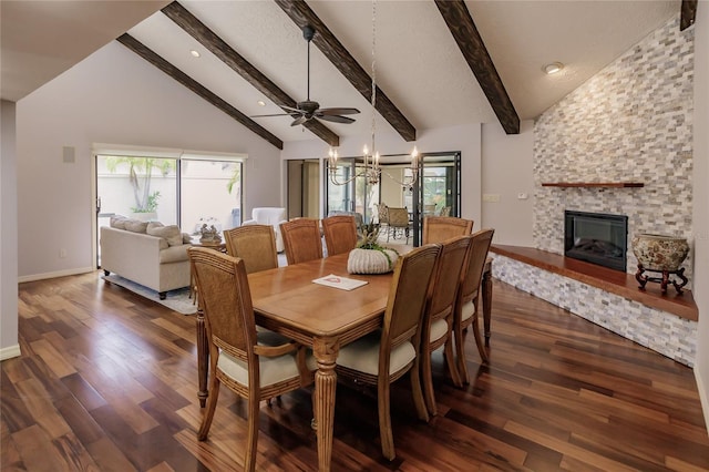 dining area featuring beam ceiling, ceiling fan, a large fireplace, dark wood-type flooring, and high vaulted ceiling