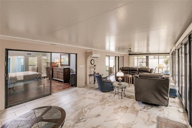 living room with a wall mounted air conditioner and ceiling fan