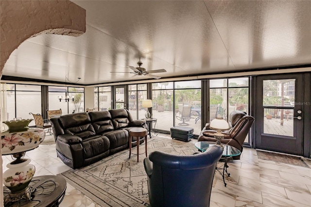 interior space with ceiling fan and a wall of windows