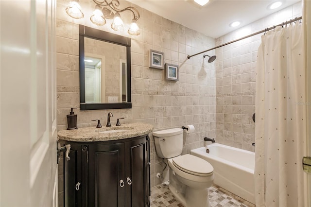 full bathroom featuring vanity, tile patterned flooring, toilet, shower / bath combo with shower curtain, and tile walls