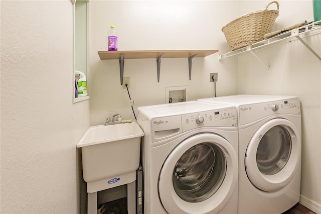 laundry area with washer and clothes dryer and sink