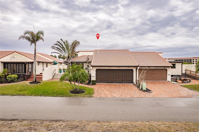 view of front of property with a garage and a front lawn