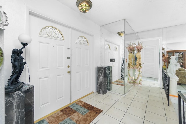 foyer entrance with light tile patterned floors