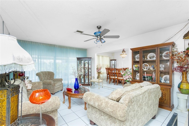 tiled living room featuring a textured ceiling and ceiling fan