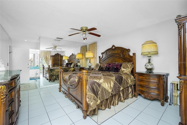 tiled bedroom featuring ceiling fan and a textured ceiling