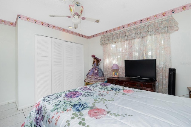 bedroom with ceiling fan, a closet, and light tile patterned floors