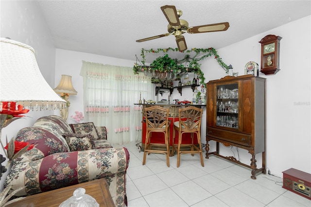 living room with a textured ceiling and ceiling fan