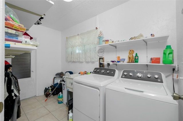 clothes washing area with light tile patterned floors and separate washer and dryer