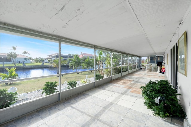 unfurnished sunroom featuring a wealth of natural light and a water view