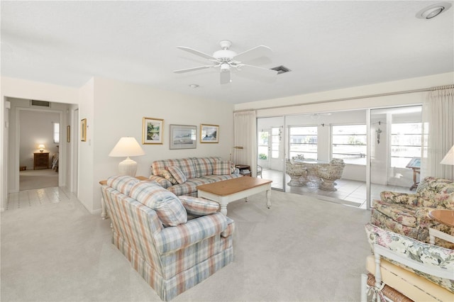 living room with light carpet and ceiling fan