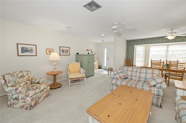 living room featuring light carpet and ceiling fan