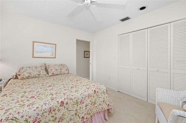 carpeted bedroom featuring ceiling fan and a closet