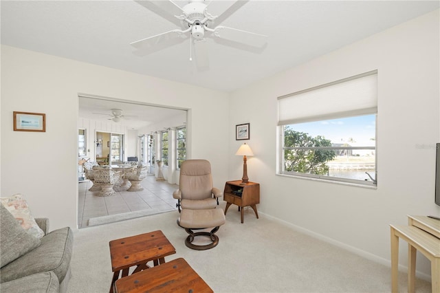 carpeted living room with ceiling fan