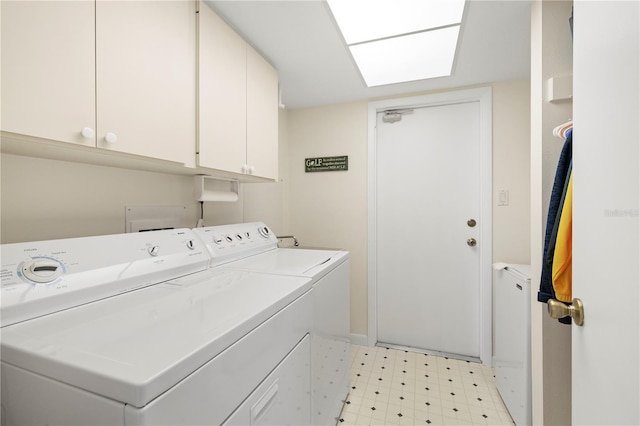 laundry room featuring washer and dryer and cabinets