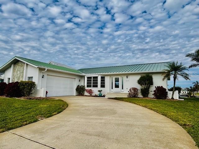 ranch-style home with a garage and a front lawn