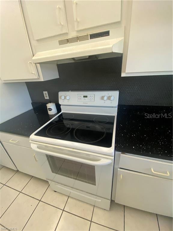 kitchen with white cabinets, white electric range oven, and light tile patterned floors