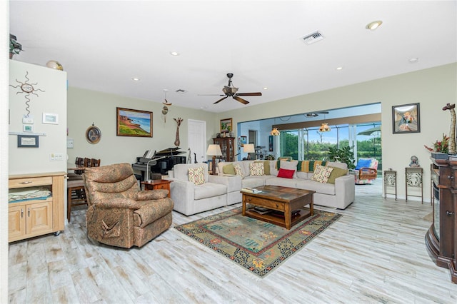 living room featuring light hardwood / wood-style flooring and ceiling fan