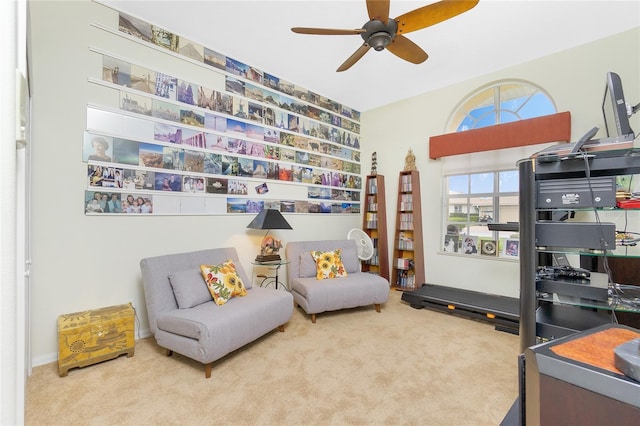 sitting room featuring carpet and ceiling fan