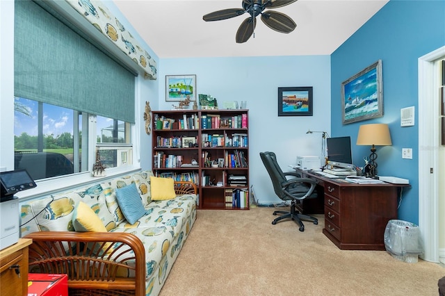 carpeted office space featuring ceiling fan