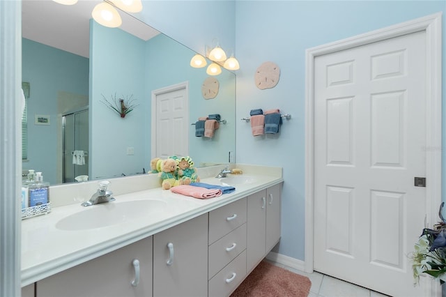 bathroom featuring tile patterned flooring, vanity, and walk in shower