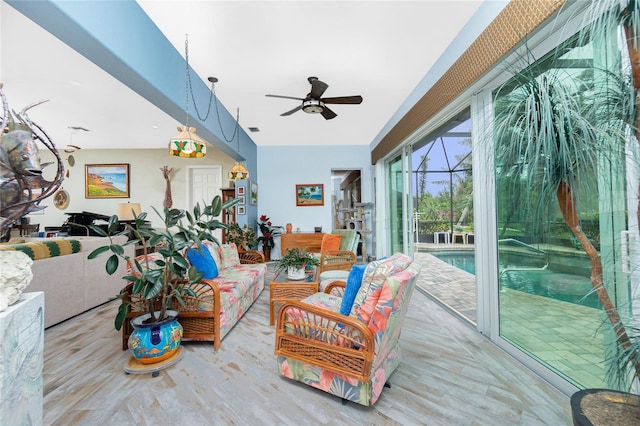 living room featuring ceiling fan and light hardwood / wood-style floors