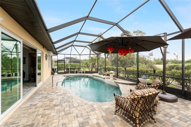 view of pool featuring a patio area and glass enclosure