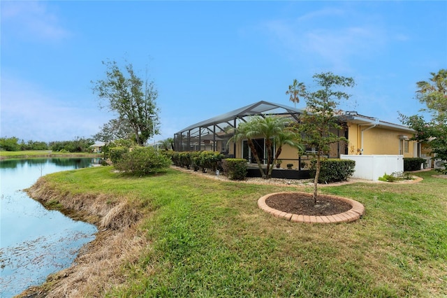 view of yard featuring a water view and a lanai