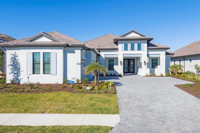 view of front of house with a front lawn and french doors