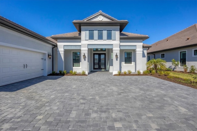 view of front of home with french doors and a garage