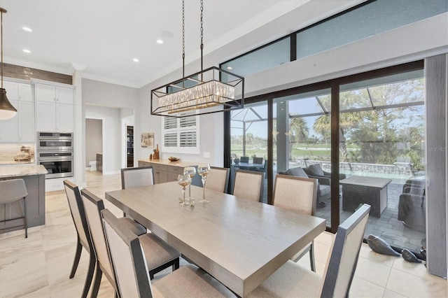 dining area with crown molding, a wealth of natural light, and a chandelier