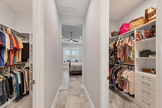 spacious closet with ceiling fan