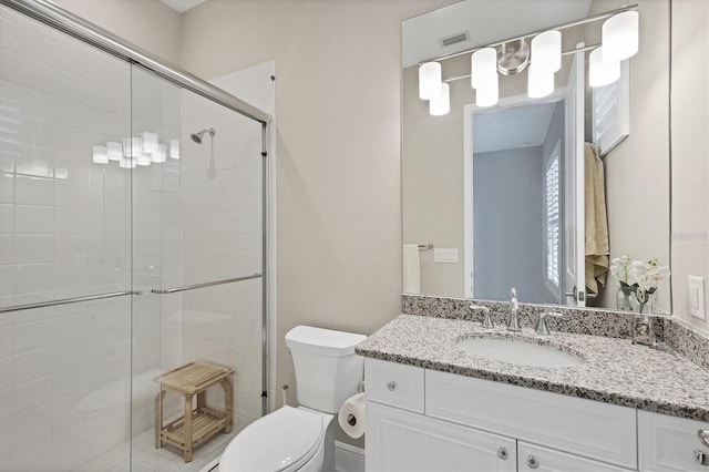 bathroom with vanity, toilet, and walk in shower